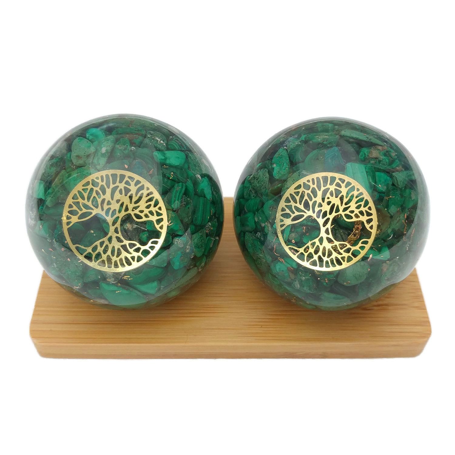 Malachite baoding balls on a display stand