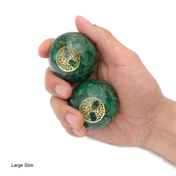Hand holding large malachite baoding balls