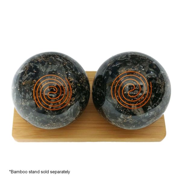 Black tourmaline baoding balls on a display stand
