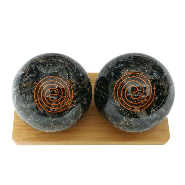 Black tourmaline baoding balls on a display stand