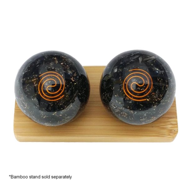 Black tourmaline baoding balls on a display stand