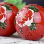 Pair of red cloisonne peony baoding balls