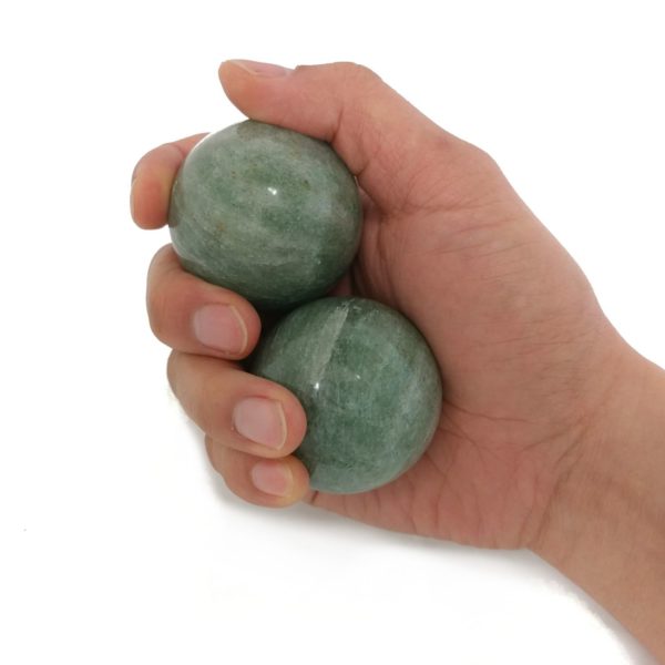 Hand holding large India jade baoding balls