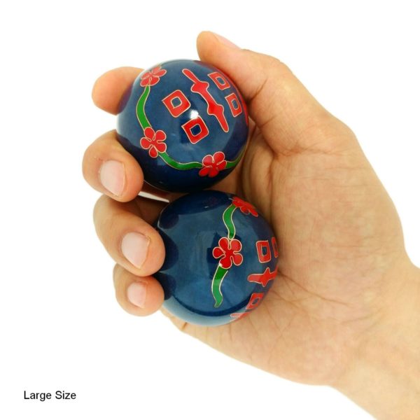 Hand holding large double happiness baoding balls