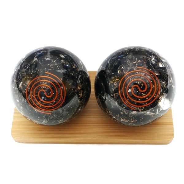 Black obsidian orgonite baoding balls on a display stand