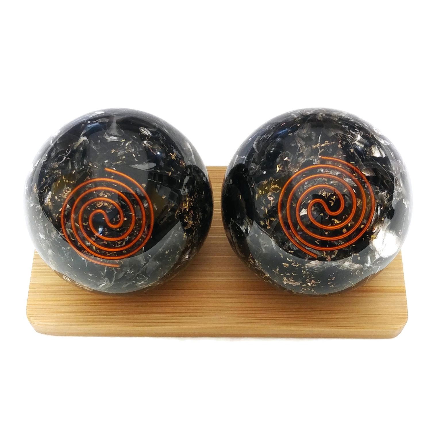 Black obsidian orgonite baoding balls on a display stand