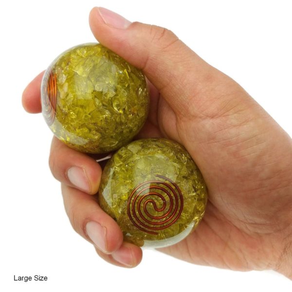 Hand holding large lemon quartz orgonite baoding balls