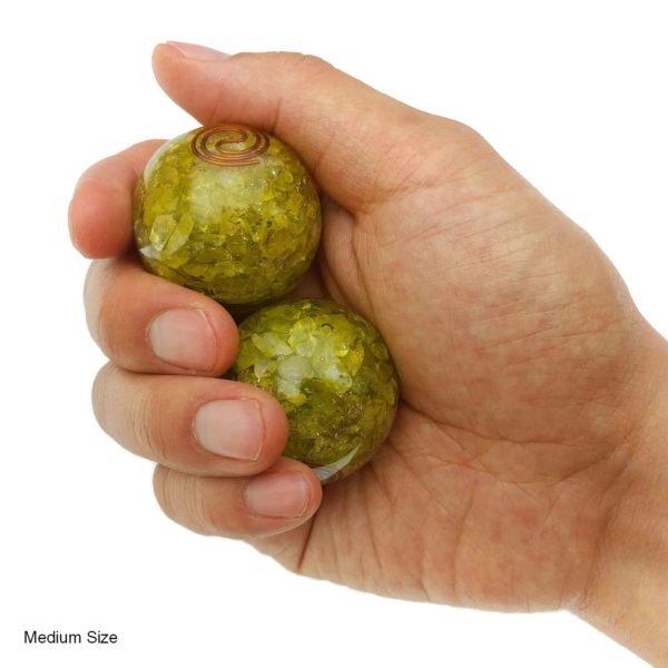 Hand holding medium lemon quartz orgonite baoding balls
