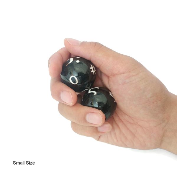 Hand holding small music baoding balls