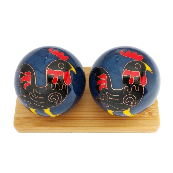 Rooster baoding balls on a bamboo display stand