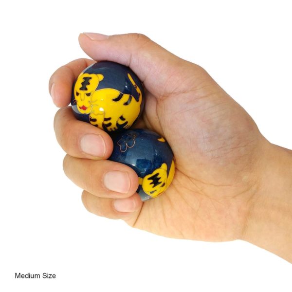 Hand holding medium tiger baoding balls