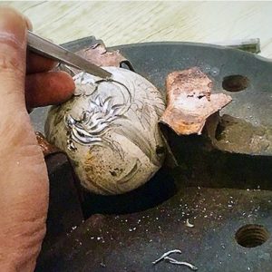 person carving baoding balls