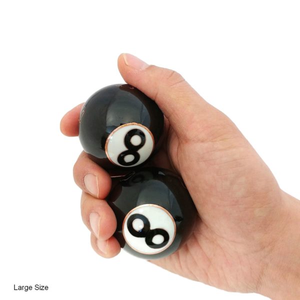 Hand holding large 8 ball baoding balls