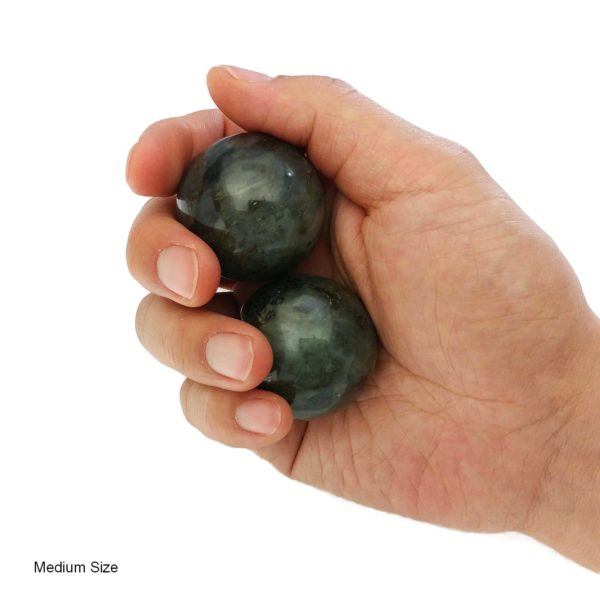 Hand holding medium labradorite baoding balls