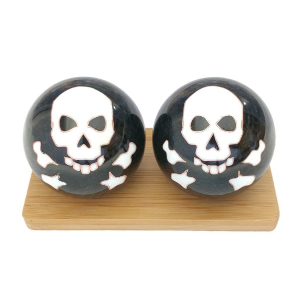 Skull and bones baoding balls on a display stand