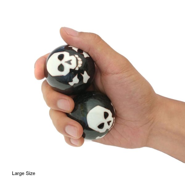 Hand holding large skull and bones baoding balls