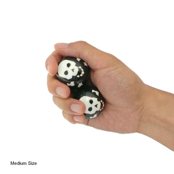 Hand holding medium skull and bones baoding balls