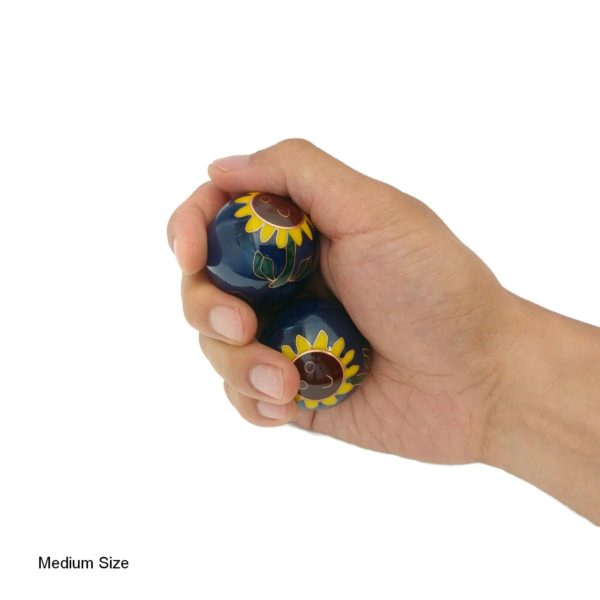 Hand holding medium sunflower baoding balls
