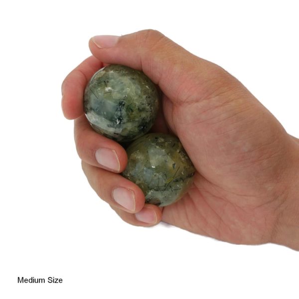 Hand holding prehnite baoding balls
