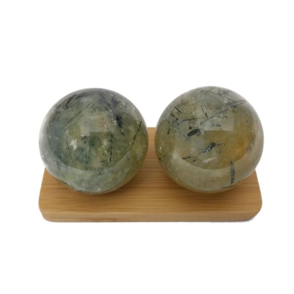 Prehnite baoding balls on a display stand