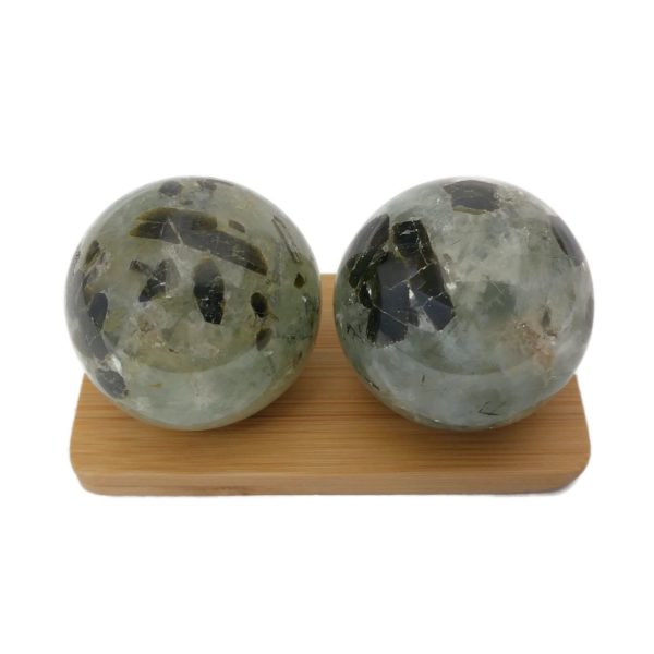 Prehnite baoding balls on a display stand