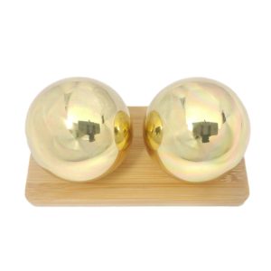 Brass baoding balls on a display stand
