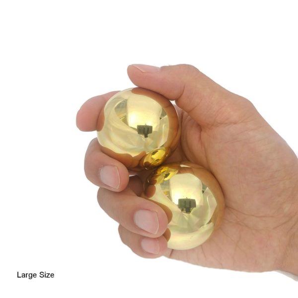 Hand holding brass baoding balls