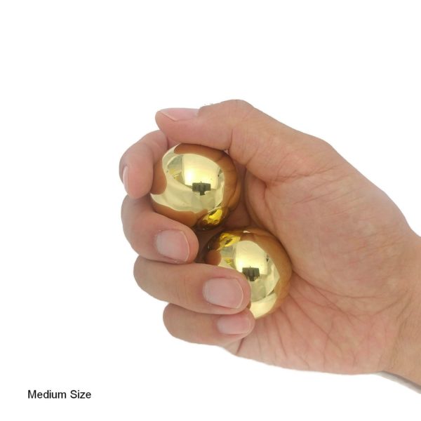 Hand holding brass baoding balls