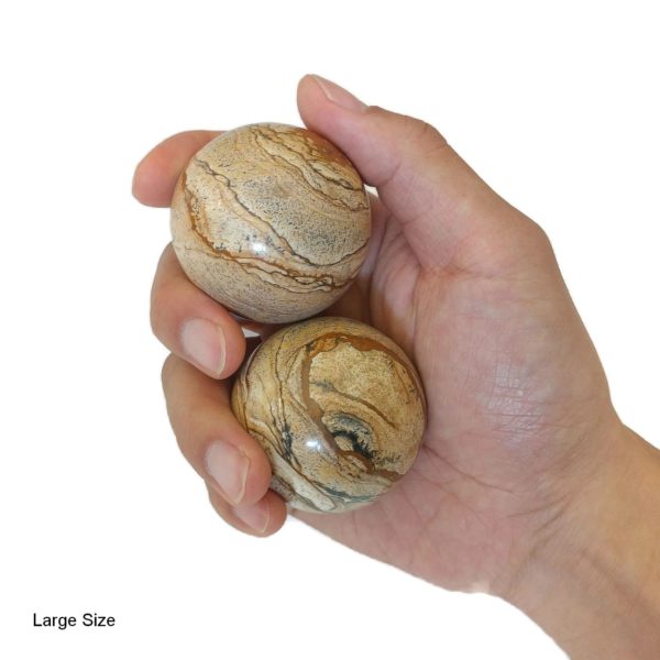 Hand holding large picture jasper baoding balls