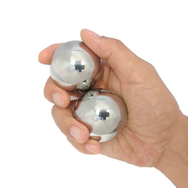 Hand holding large stainless steel baoding balls