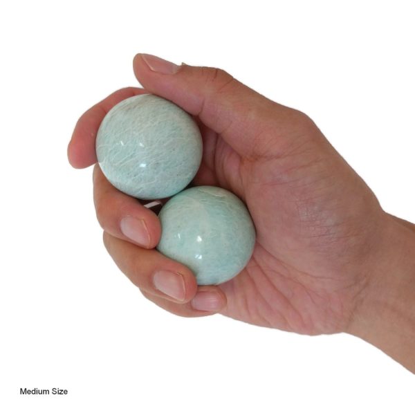 Hand holding medium Amazonite baoding balls